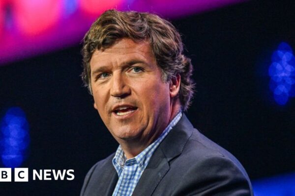 Tucker Carlson: Russian state media revels in Moscow visit